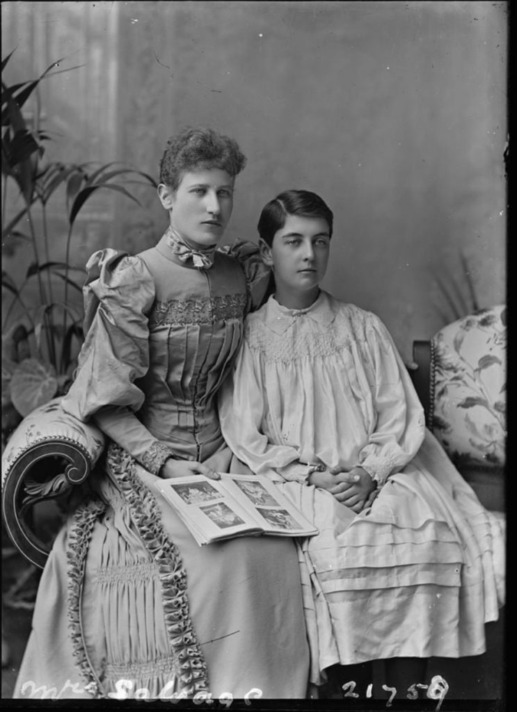 A posed Victorian photograph featuring a seated woman and boy